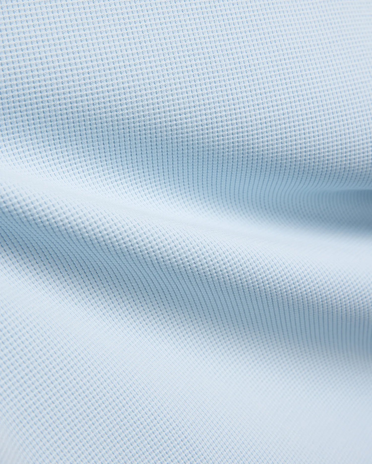 Kids Maxton Waffle Tee fabric in a soft sky blue, showcasing its distinctive raised waffle knit texture with subtle folds, ideal for comfortable, refined streetwear.