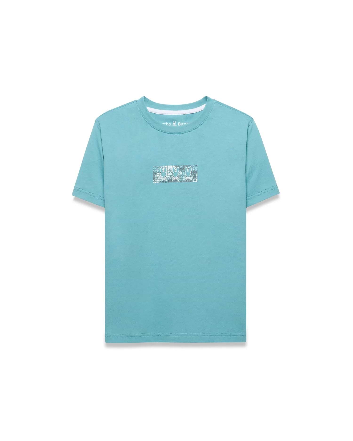 Kids' Alfie Back Graphic Tee in aqua blue, featuring a classic fit and smooth jersey knit. A rectangular center chest graphic displays repeating white and grey Psycho Bunny skull logos. (1)