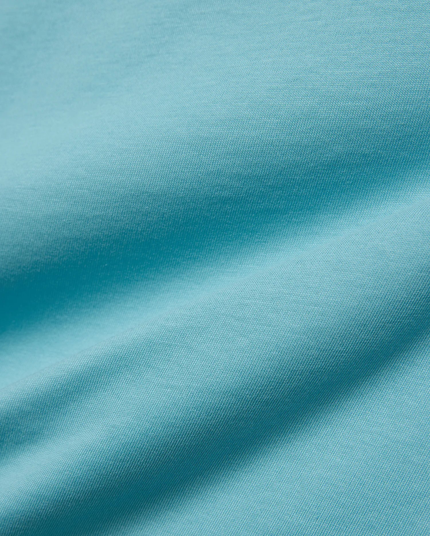 Kids' Alfie Back Graphic Tee in vibrant aqua blue, soft jersey knit fabric with subtle texture and flowing drapes, featuring a back graphic for a stylish, comfortable look. (5)
