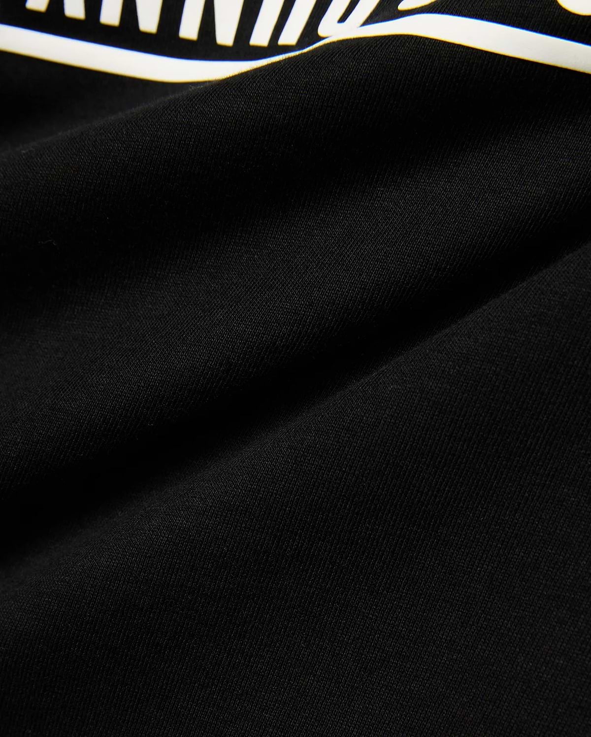 Kids' Raj Pima Graphic Tee, a premium black Pima cotton jersey knit with a soft texture, featuring a prominent, bold white graphic print, embodying refined streetwear style. (6)
