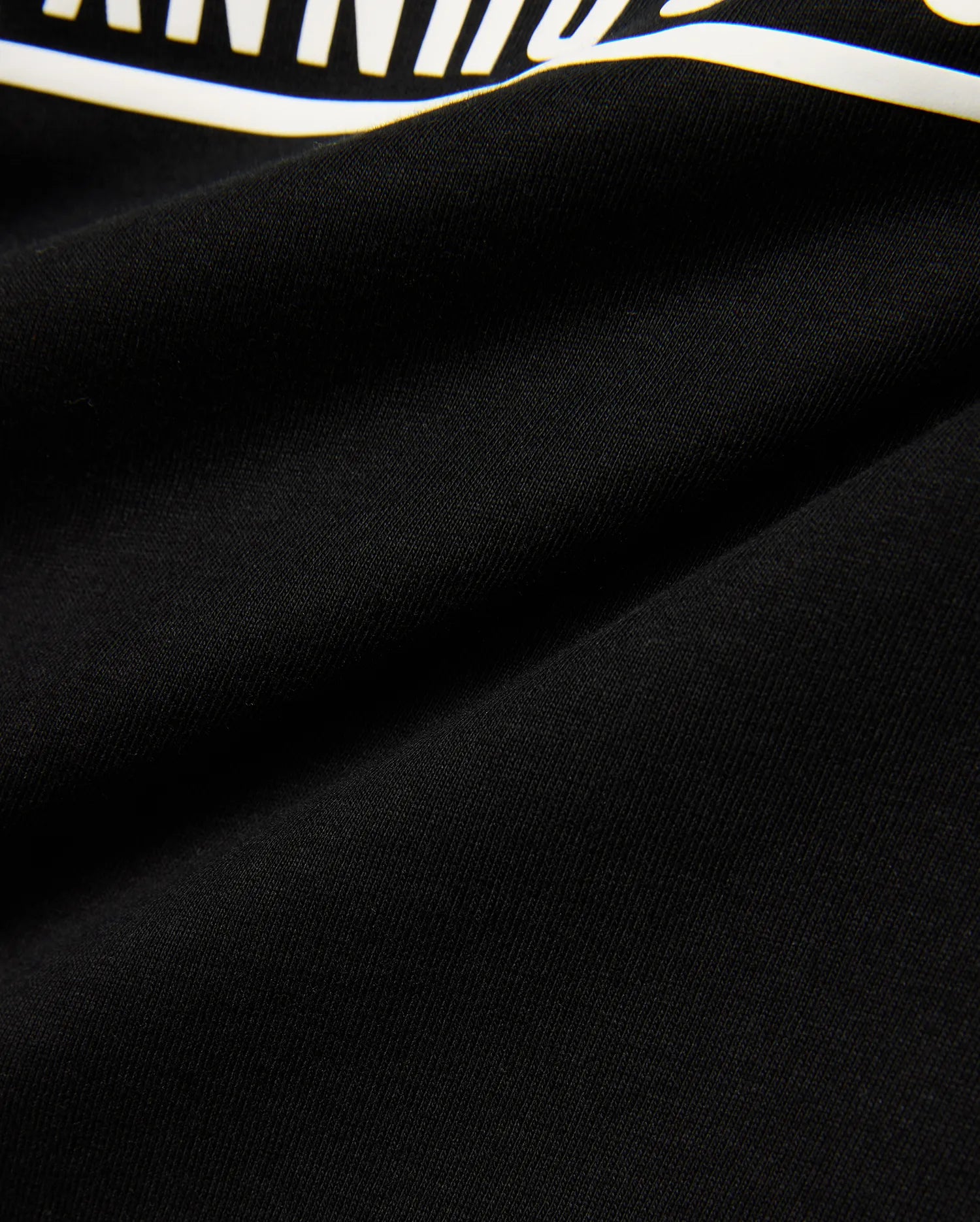 Kids' Raj Pima Graphic Tee, a premium black Pima cotton jersey knit with a soft texture, featuring a prominent, bold white graphic print, embodying refined streetwear style. (6)