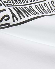 Kids' Raj Pima Graphic Tee in soft white Pima jersey knit, featuring a prominent, bold black PSYCHO BUNNY text graphic print, embodying premium streetwear style. (6)