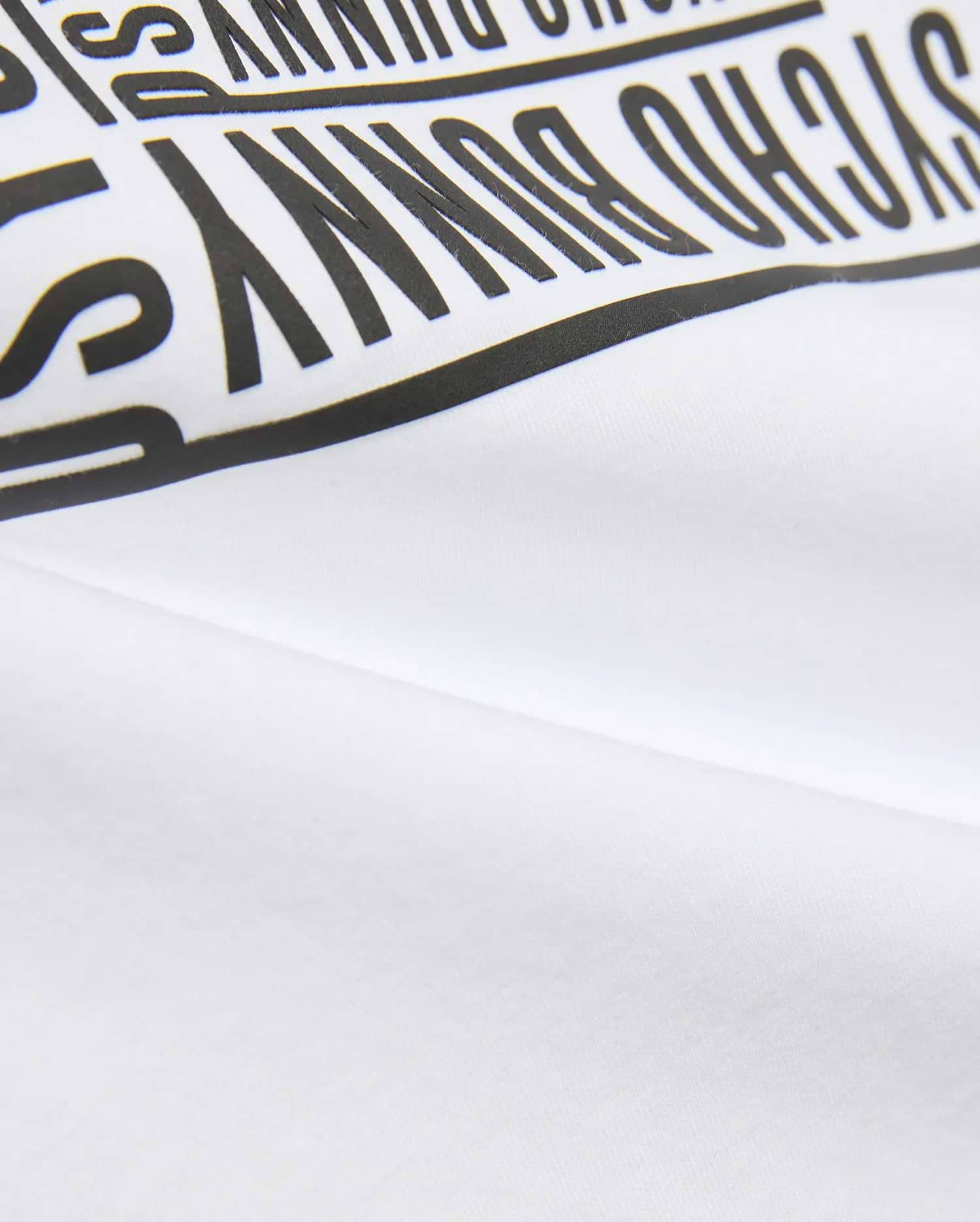 Kids' Raj Pima Graphic Tee in soft white Pima jersey knit, featuring a prominent, bold black PSYCHO BUNNY text graphic print, embodying premium streetwear style. (6)