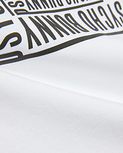Kids' Raj Pima Graphic Tee in soft white Pima jersey knit, featuring a prominent, bold black PSYCHO BUNNY text graphic print, embodying premium streetwear style. (6)