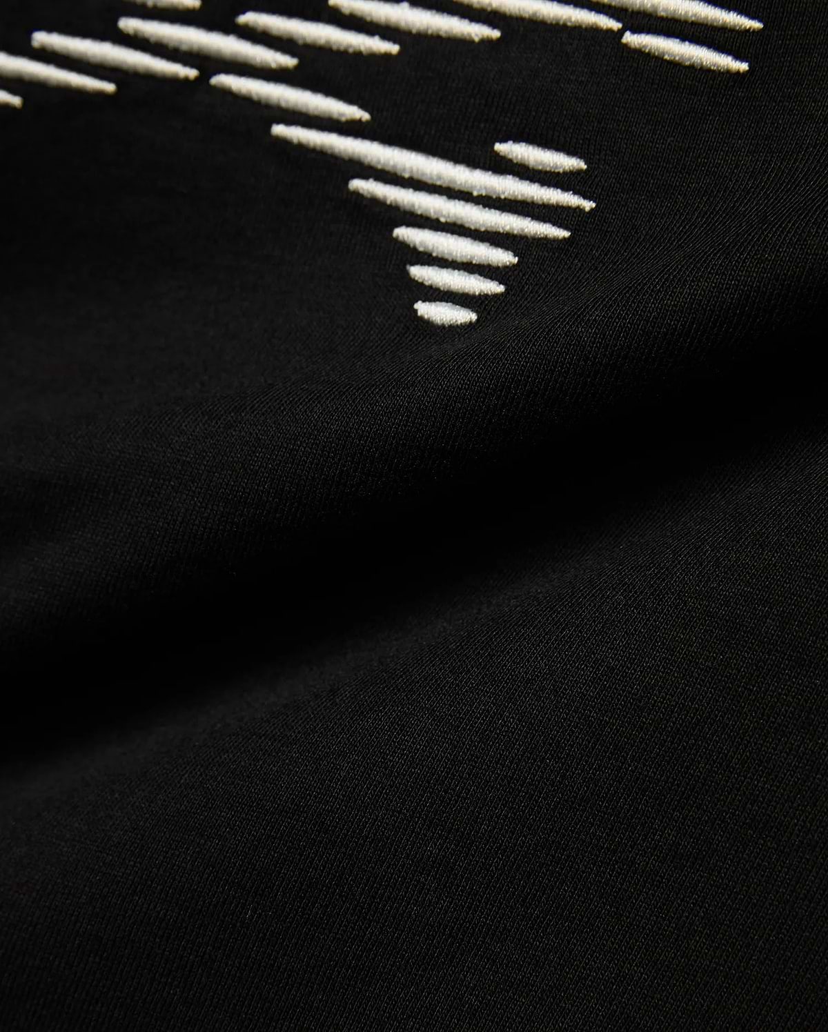 Kids' Slade Pima Graphic Tee, a black Pima cotton jersey t-shirt with a refined streetwear feel, featuring a prominent white embroidered stylized graphic design. (6)