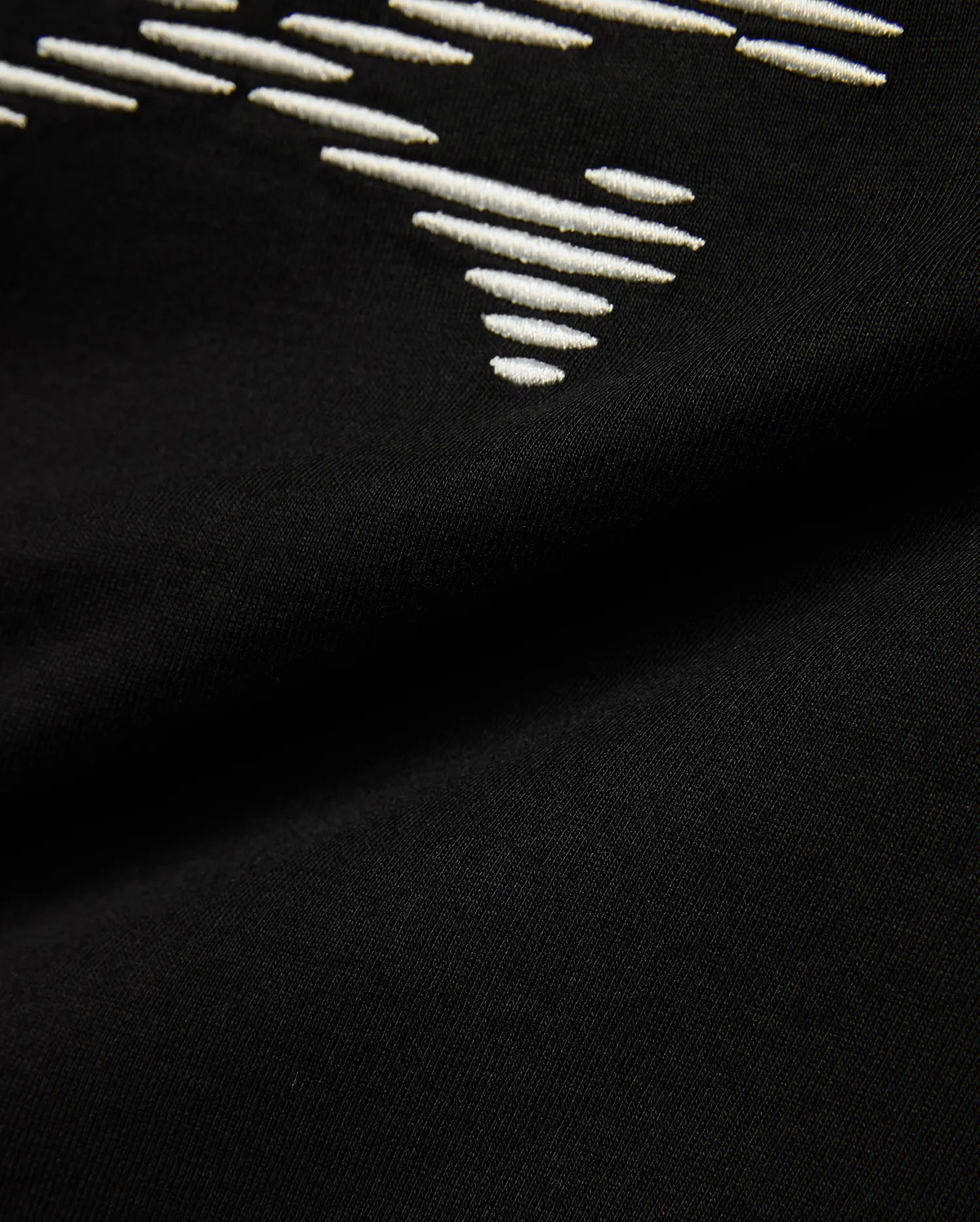 Kids' Slade Pima Graphic Tee, a black Pima cotton jersey t-shirt with a refined streetwear feel, featuring a prominent white embroidered stylized graphic design. (6)