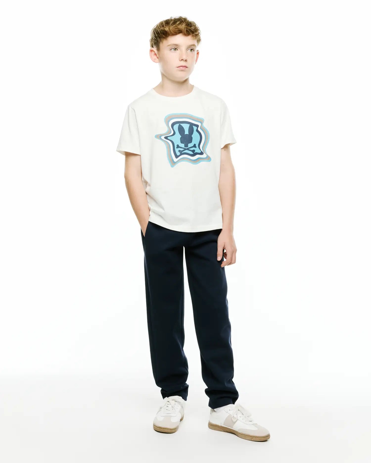 Kids' Klaus Pima Graphic Tee, a classic fit off-white Pima cotton jersey t-shirt with a large center chest graphic featuring the Psycho Bunny skull logo in shades of blue and grey within a wavy, stylized shield. (4)