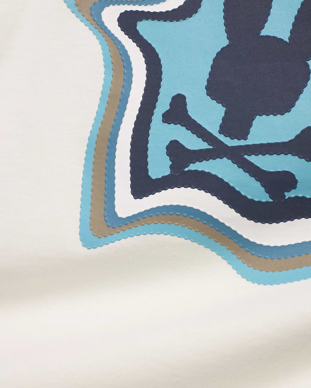 KIDS' KLAUS Pima Graphic Tee in off-white jersey, featuring a large, layered graphic with a dark blue bunny skull and crossbones on a light blue background, accented with white, medium blue, and taupe scalloped layers. (5)