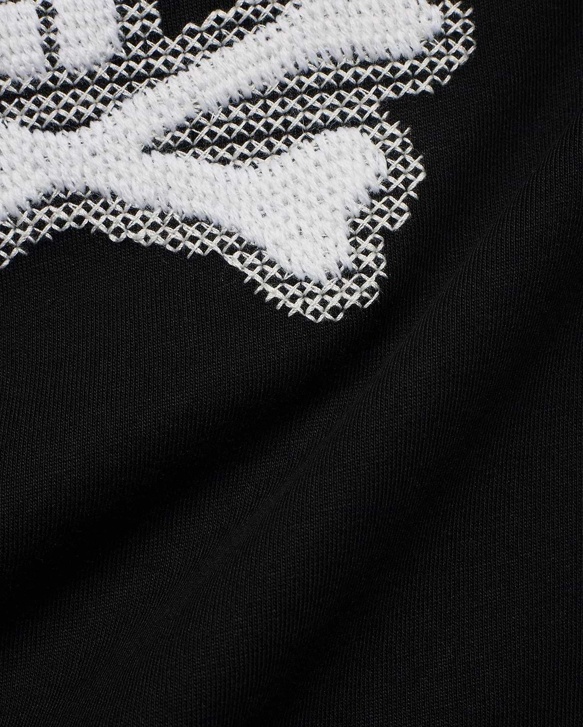 Kids' Samson Pima Graphic Tee in black Pima jersey knit, featuring a large white cross-stitch Psycho Bunny skull graphic. (6)