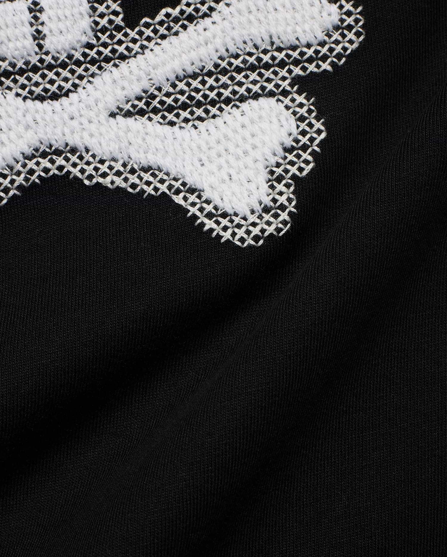 Kids' Samson Pima Graphic Tee in black Pima jersey knit, featuring a large white cross-stitch Psycho Bunny skull graphic. (6)