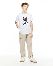 Kids' Samson Pima Graphic Tee, a white classic fit jersey t-shirt featuring a large black and pink Psycho Bunny skull and crossbones graphic print on the center chest, paired with relaxed fit khaki cargo pants. (5)