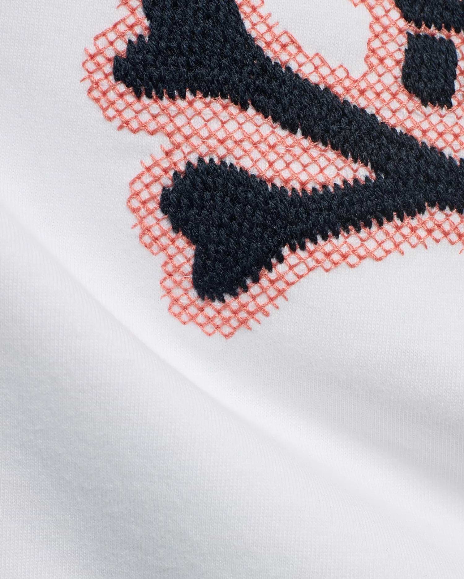 Kids' Samson Pima Graphic Tee in white Pima cotton jersey, featuring a large embroidered Psycho Bunny skull graphic with solid dark blue and coral cross-stitch details. (6)