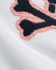 Kids' Samson Pima Graphic Tee in white Pima cotton jersey, featuring a large embroidered Psycho Bunny skull graphic with solid dark blue and coral cross-stitch details. (6)