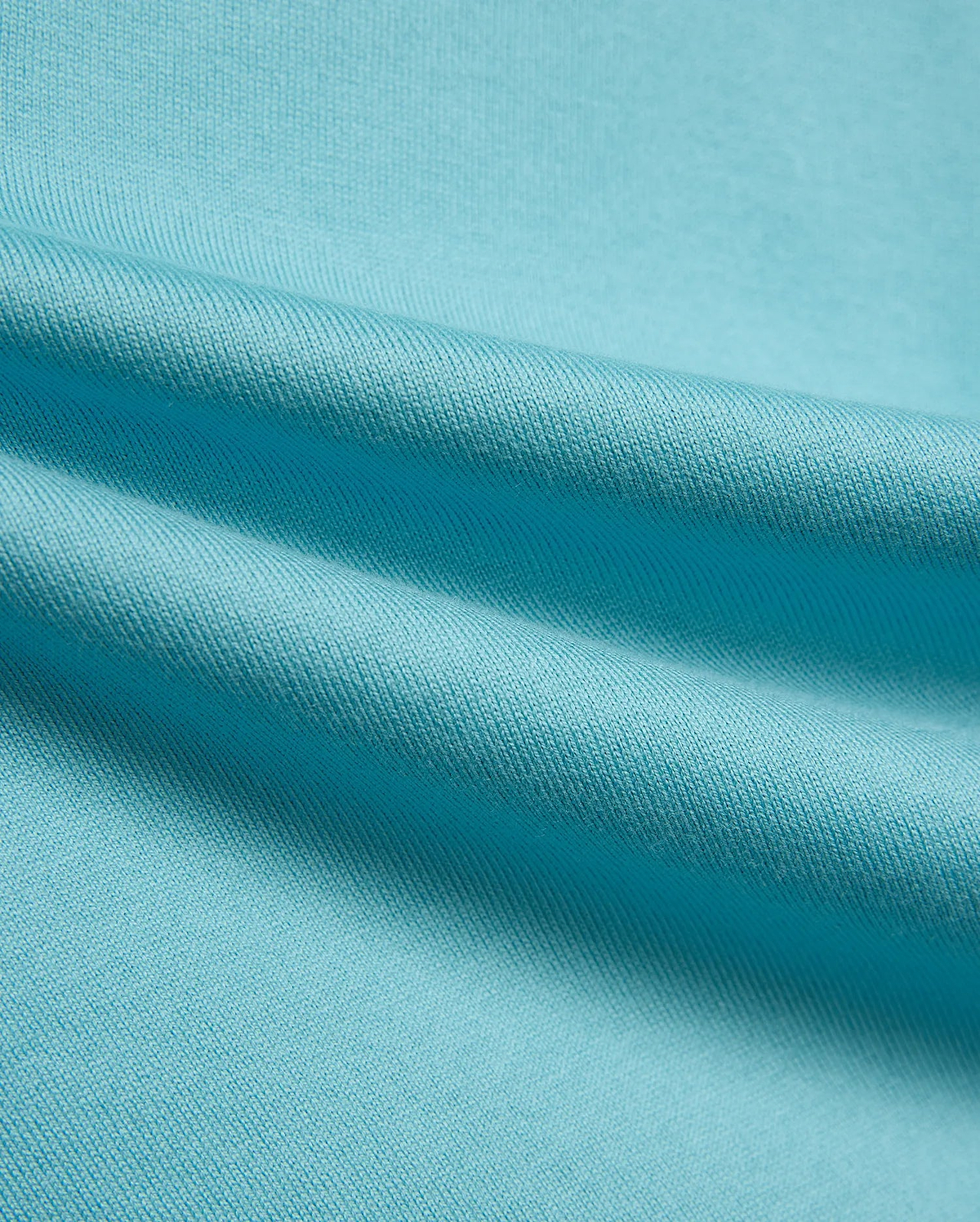 Kid's Norman Longsleeve Oversized Tee in vibrant aqua blue, showcasing its premium, finely woven cotton jersey knit fabric with soft, flowing drapes. (6)