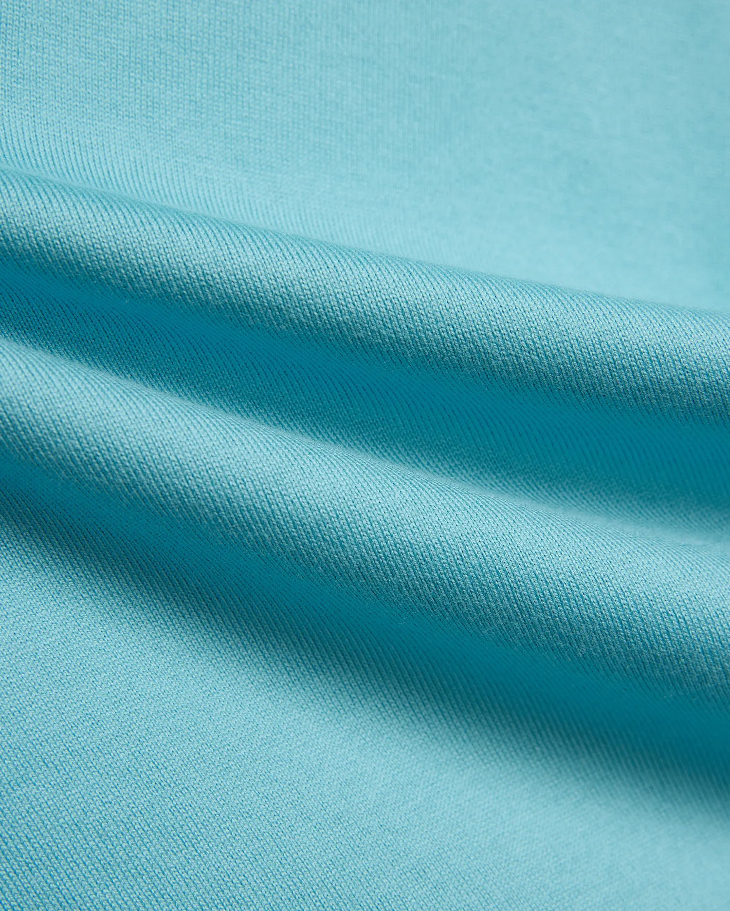 Kid's Norman Longsleeve Oversized Tee in vibrant aqua blue, showcasing its premium, finely woven cotton jersey knit fabric with soft, flowing drapes. (6)