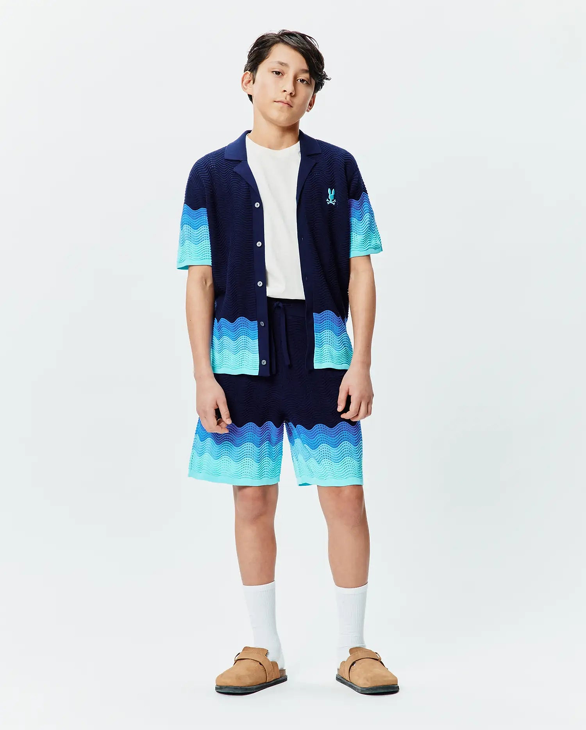 Kids Holden Oversized Knit Shirt and matching shorts set in navy blue with wavy gradient blue stripes, featuring a relaxed fit, textured knit fabric, and a small embroidered Psycho Bunny logo on the chest. (4)