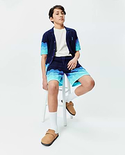 Kids Holden Oversized Knit Shirt and matching shorts in navy blue with a wavy light blue and turquoise knit pattern, featuring a small embroidered Psycho Bunny skull logo on the left chest. (3)