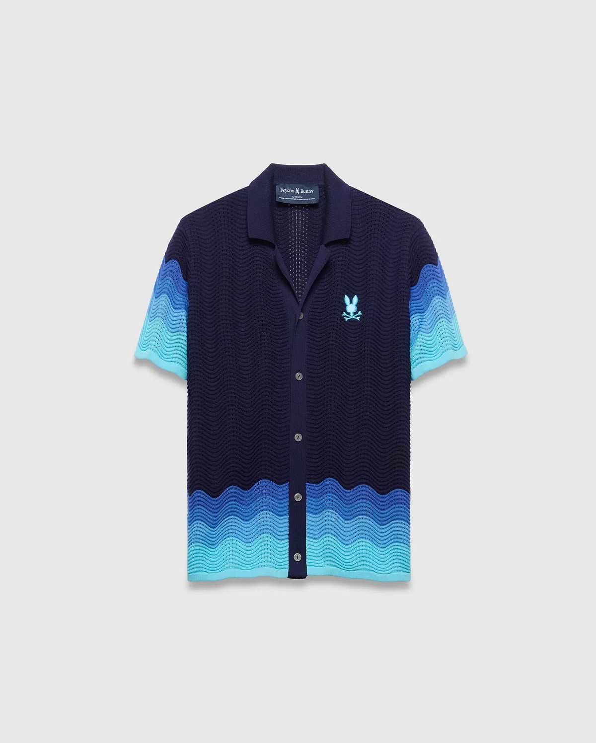Kids Holden Oversized Knit Shirt, navy with a wavy knit pattern in shades of blue, short sleeves, full button-front, and an embroidered light blue Psycho Bunny skull logo on the left chest. (5)