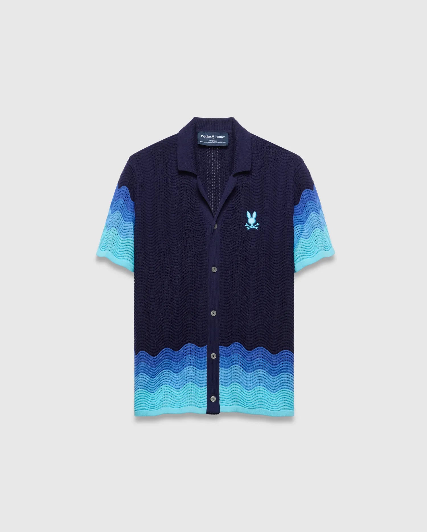 Kids Holden Oversized Knit Shirt, navy with a wavy knit pattern in shades of blue, short sleeves, full button-front, and an embroidered light blue Psycho Bunny skull logo on the left chest. (5)
