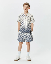 Psycho Bunny Kids Tobias Tencel Shirt and matching shorts, cream with a blue geometric diamond pattern, relaxed fit, featuring a gradient effect on the shirt.