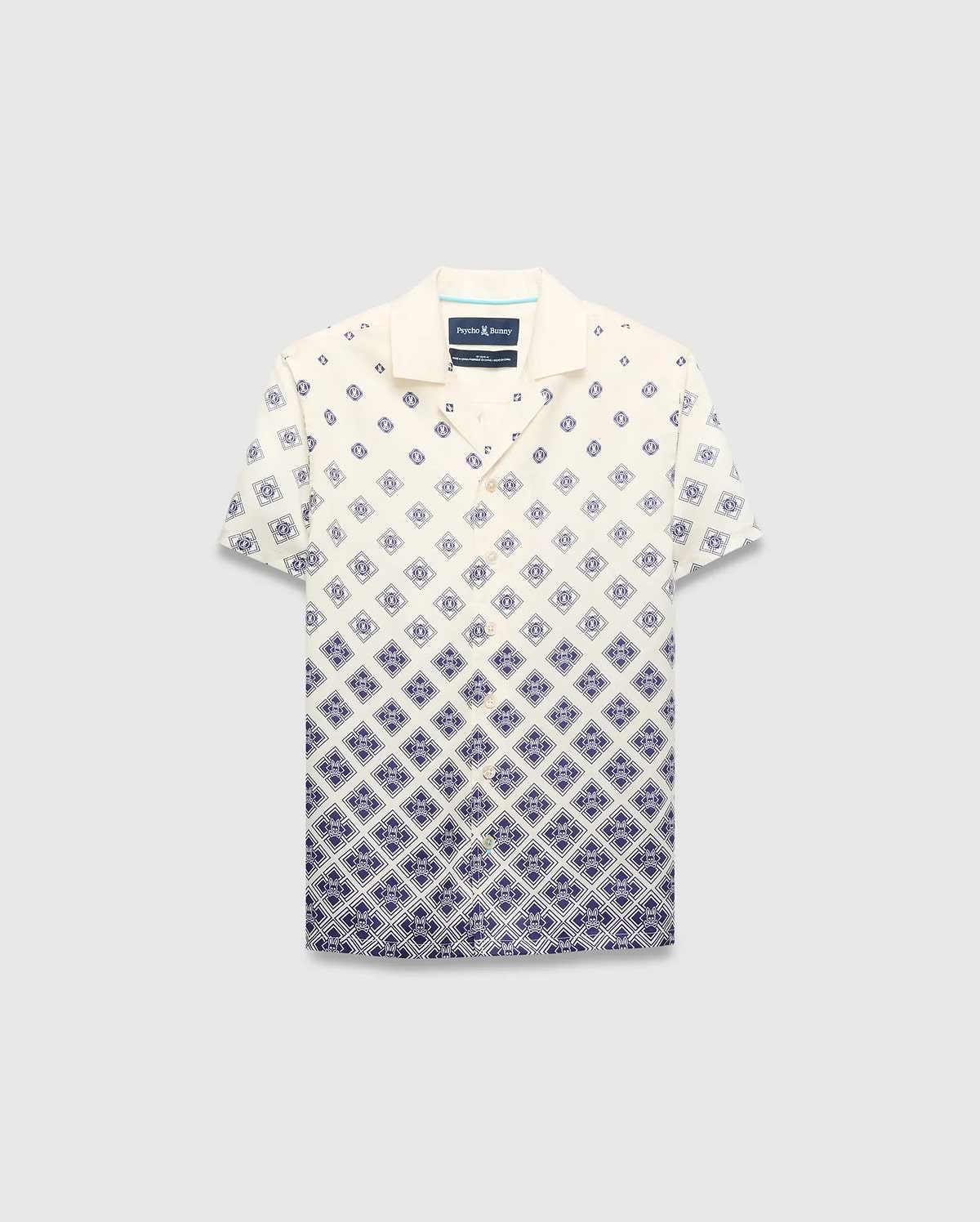 Kids Tobias Tencel Shirt in cream with a navy blue gradient diamond pattern featuring the Psycho Bunny skull logo, a relaxed fit, camp collar, and button-front.