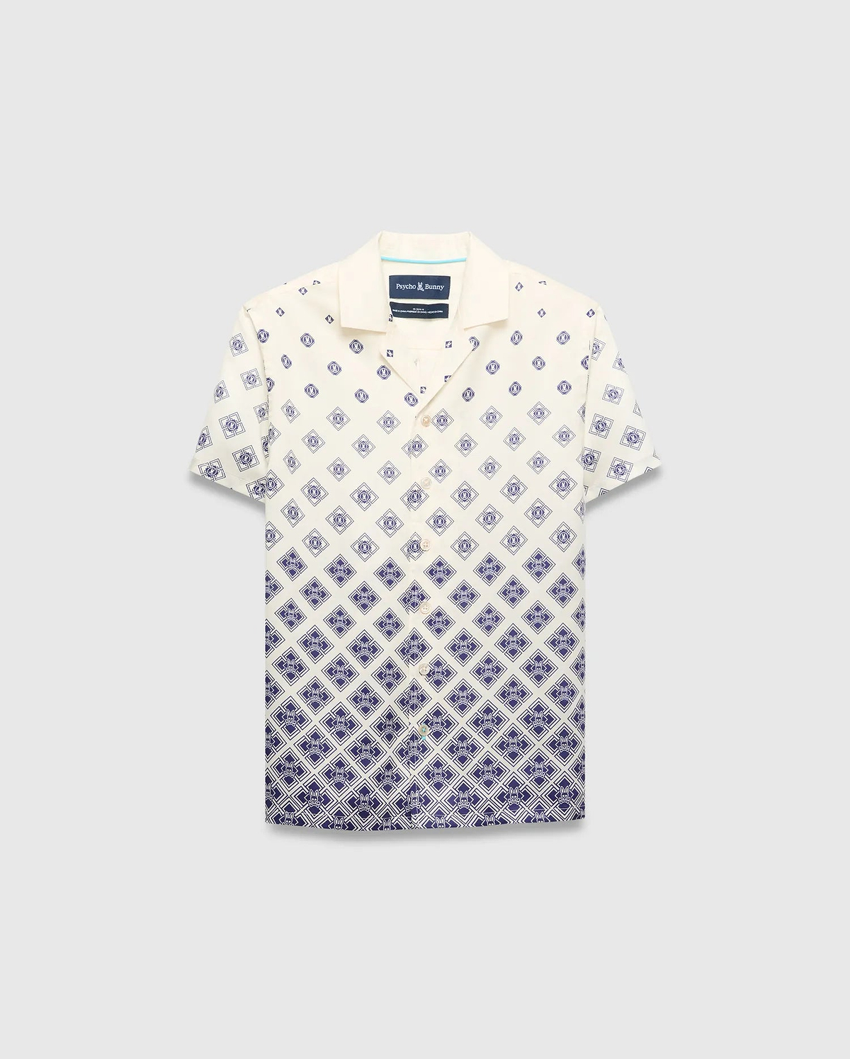 Kids Tobias Tencel Shirt in cream with a navy blue gradient diamond pattern featuring the Psycho Bunny skull logo, a relaxed fit, camp collar, and button-front.