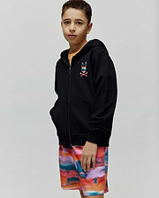 Kids Raphael French Terry Full Zip Hoodie in black, featuring a relaxed fit and a small, embroidered, multi-colored Psycho Bunny skull and crossbones logo on the left chest.