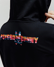 Kids Raphael French Terry Full Zip Hoodie in black, featuring a large, vibrant abstract multicolor Psycho Bunny text and bunny skull logo on the upper back, with a classic fit.