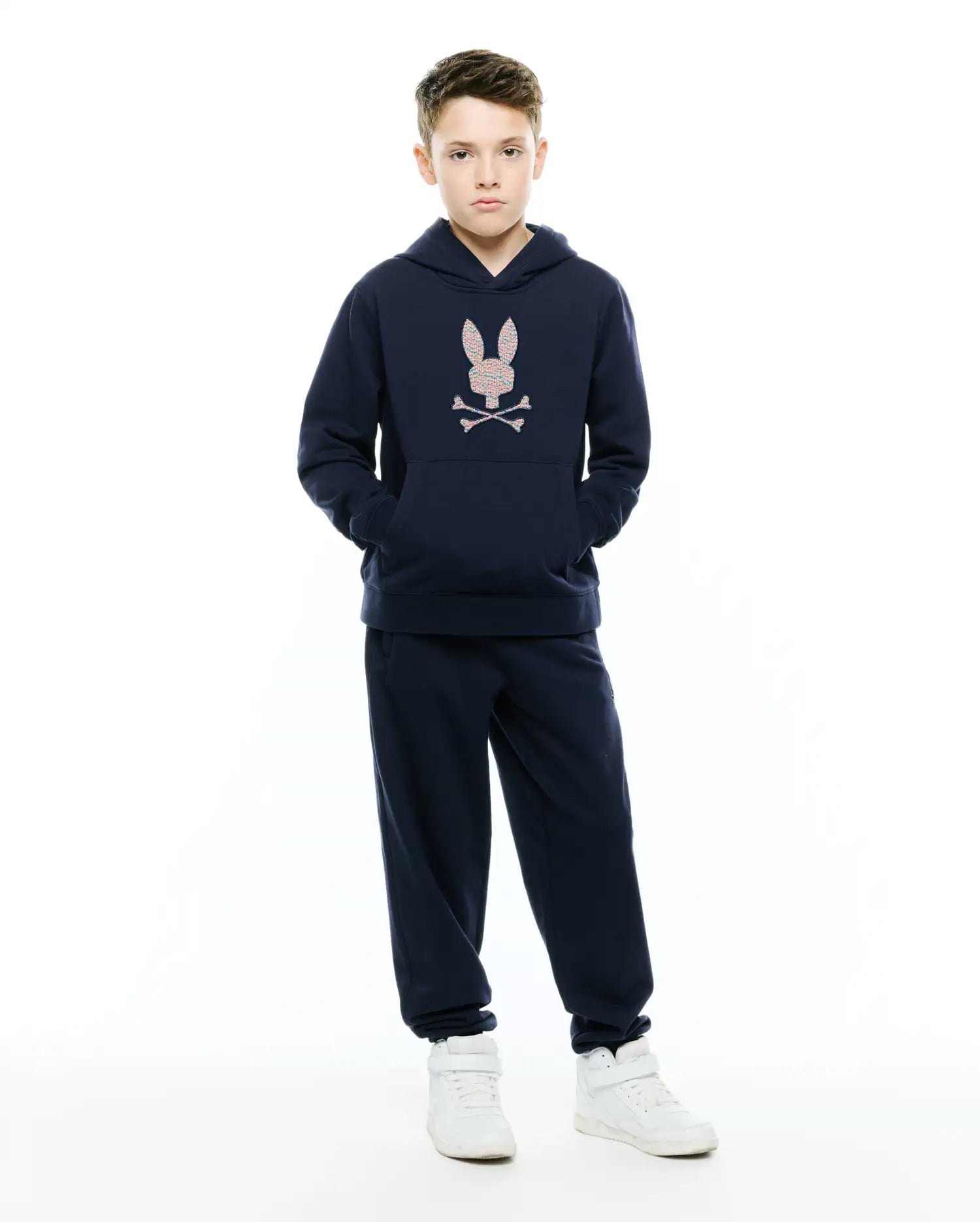 Navy Kids Darcy Hoodie in soft french terry, featuring a relaxed fit, front pouch pocket, and a large pink and white embroidered Psycho Bunny skull logo on the chest.