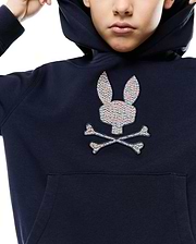 Kids Darcy Hoodie, a navy relaxed fit french terry hoodie with a large, center chest embroidered Psycho Bunny skull logo featuring a vibrant multicolored, textured weave and a front kangaroo pocket.