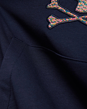 Kids Darcy Hoodie in deep navy blue, featuring a large, embroidered multicolored woven Psycho Bunny skull and crossbones logo and a front kangaroo pocket detail on soft knit fabric.