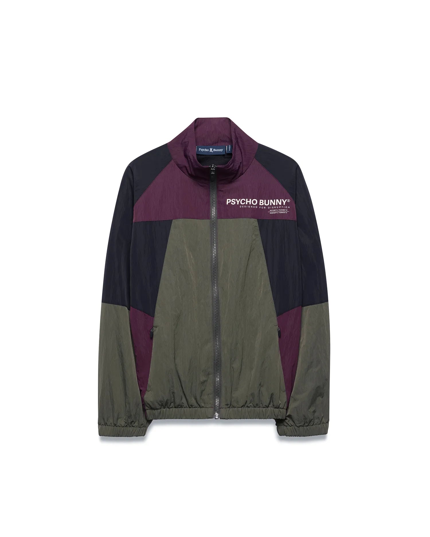 Kids Alder Nylon Colorblock Jacket in olive green, black, and deep purple, featuring a full zip, stand collar, and large white Psycho Bunny chest logo with Designed For Disruption text. Relaxed fit, crinkled nylon.