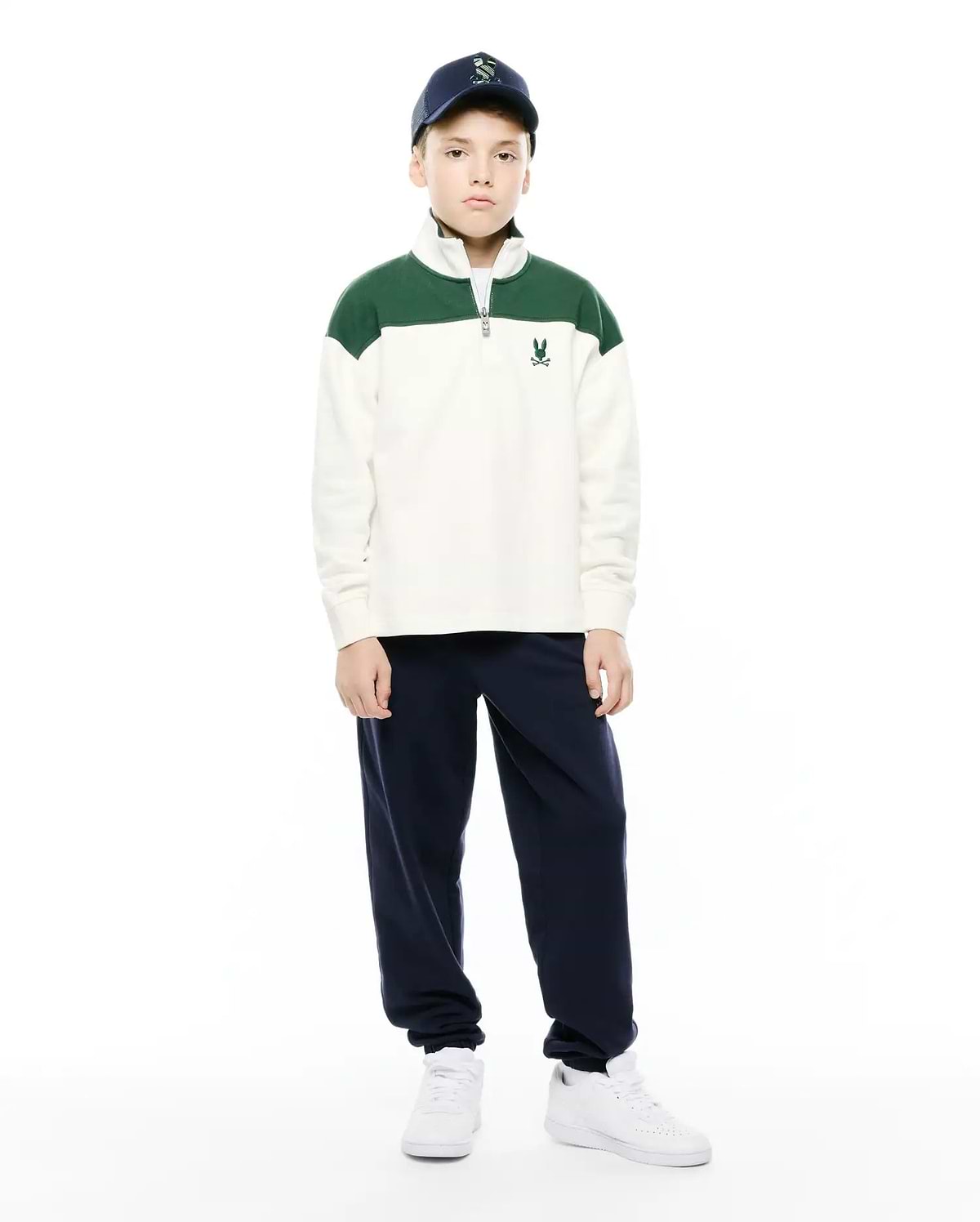 Kids Gabe French Terry 1/4 Zip, a relaxed fit cream pullover with green color-block shoulders, soft French terry fabric, a silver 1/4 zip, and a small embroidered Psycho Bunny skull logo on the left chest. (4)