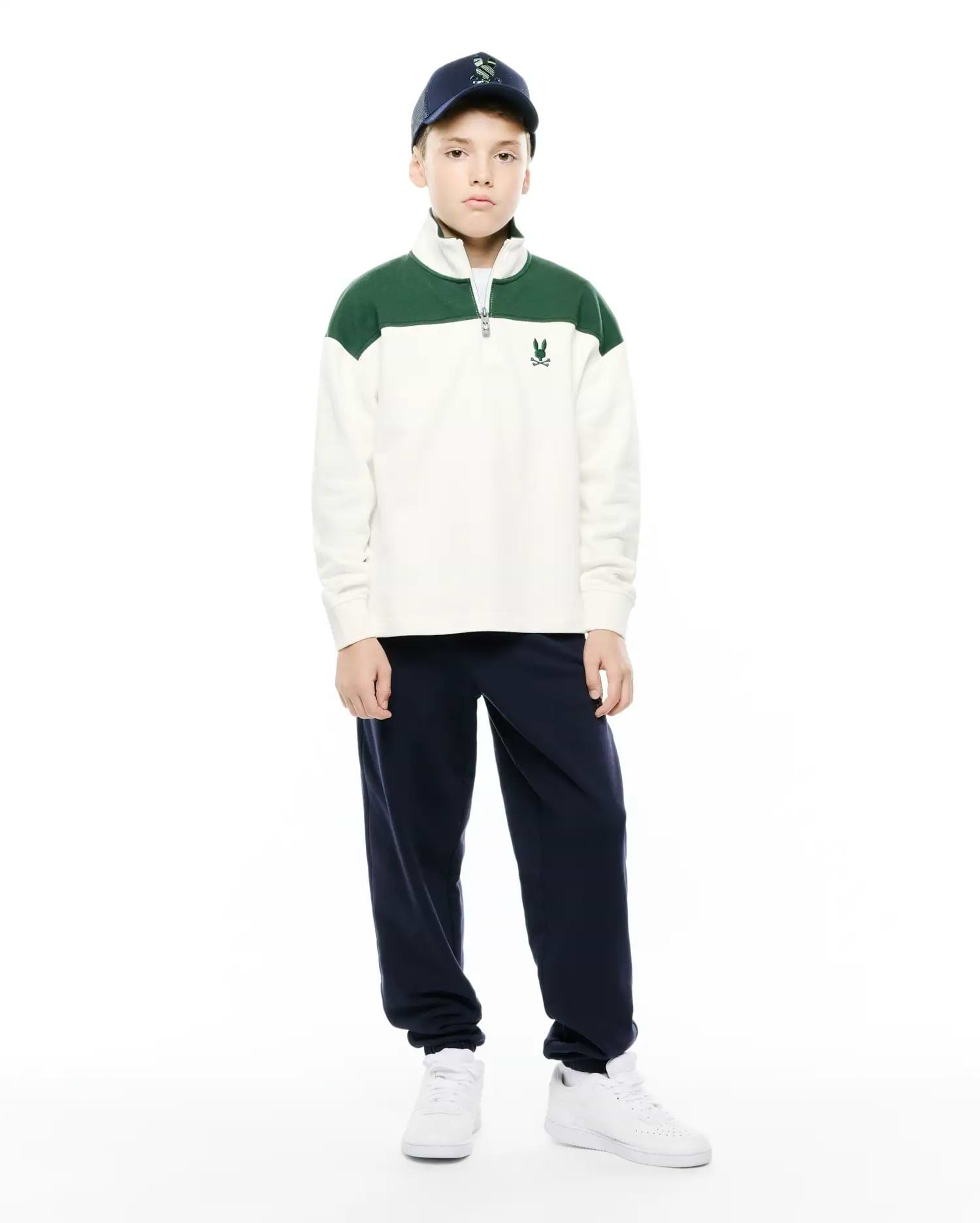 Kids Gabe French Terry 1/4 Zip, a relaxed fit cream pullover with green color-block shoulders, soft French terry fabric, a silver 1/4 zip, and a small embroidered Psycho Bunny skull logo on the left chest. (4)