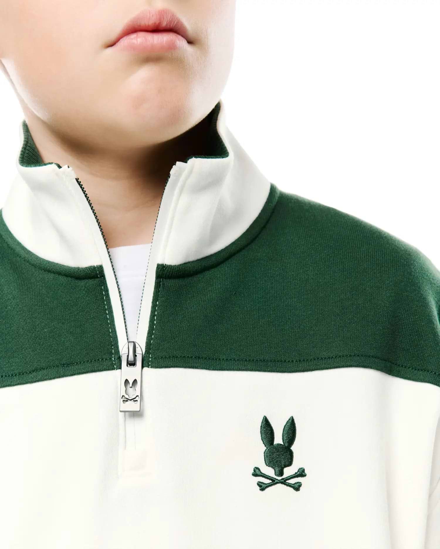Kids Gabe French Terry 1/4 Zip, color-blocked in dark green and off-white, features a quarter-zip with a branded zipper pull and an embroidered dark green Psycho Bunny skull logo on the left chest. (2)