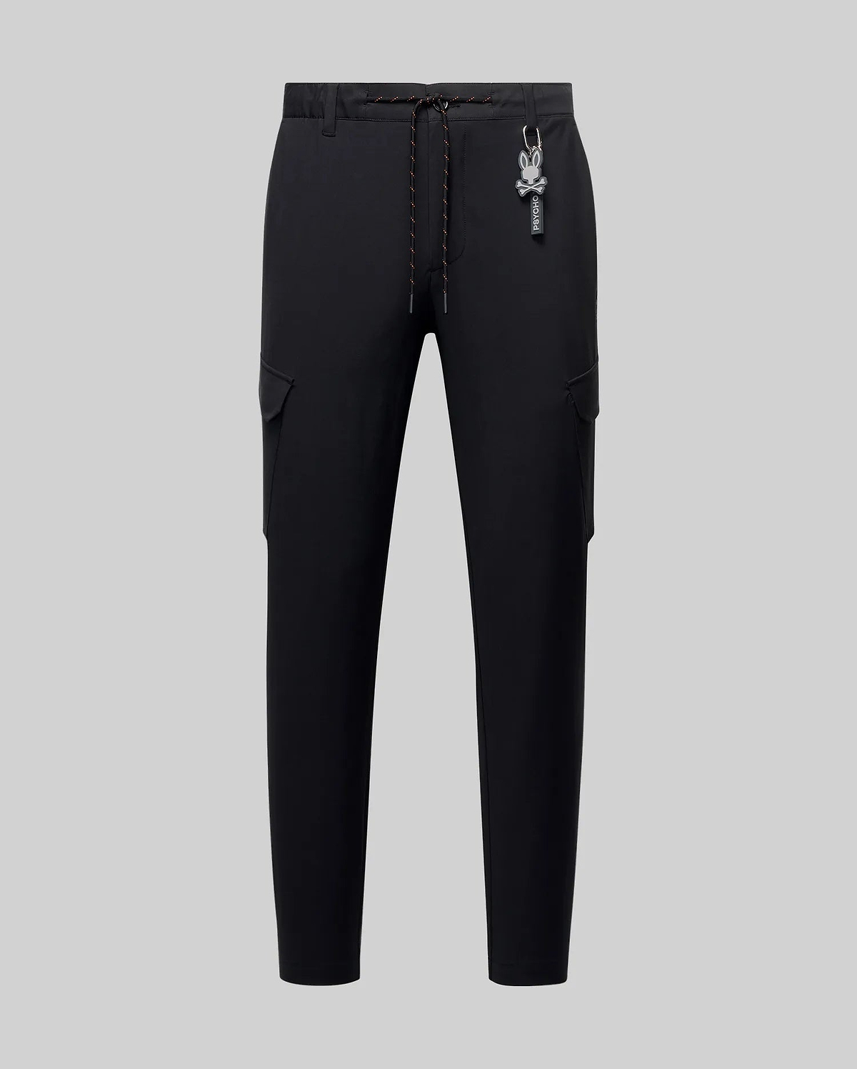 Black Mens Luka Cargo Pant in a slim fit, featuring smooth fabric, side cargo pockets, an orange-flecked drawstring, and a detachable Psycho Bunny skull logo keychain.