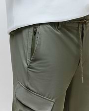 Mens Luka Cargo Pant in olive green, crafted from smooth technical fabric, featuring a drawstring waist with orange flecks, a zippered hip pocket, and a side cargo pocket for a relaxed fit.