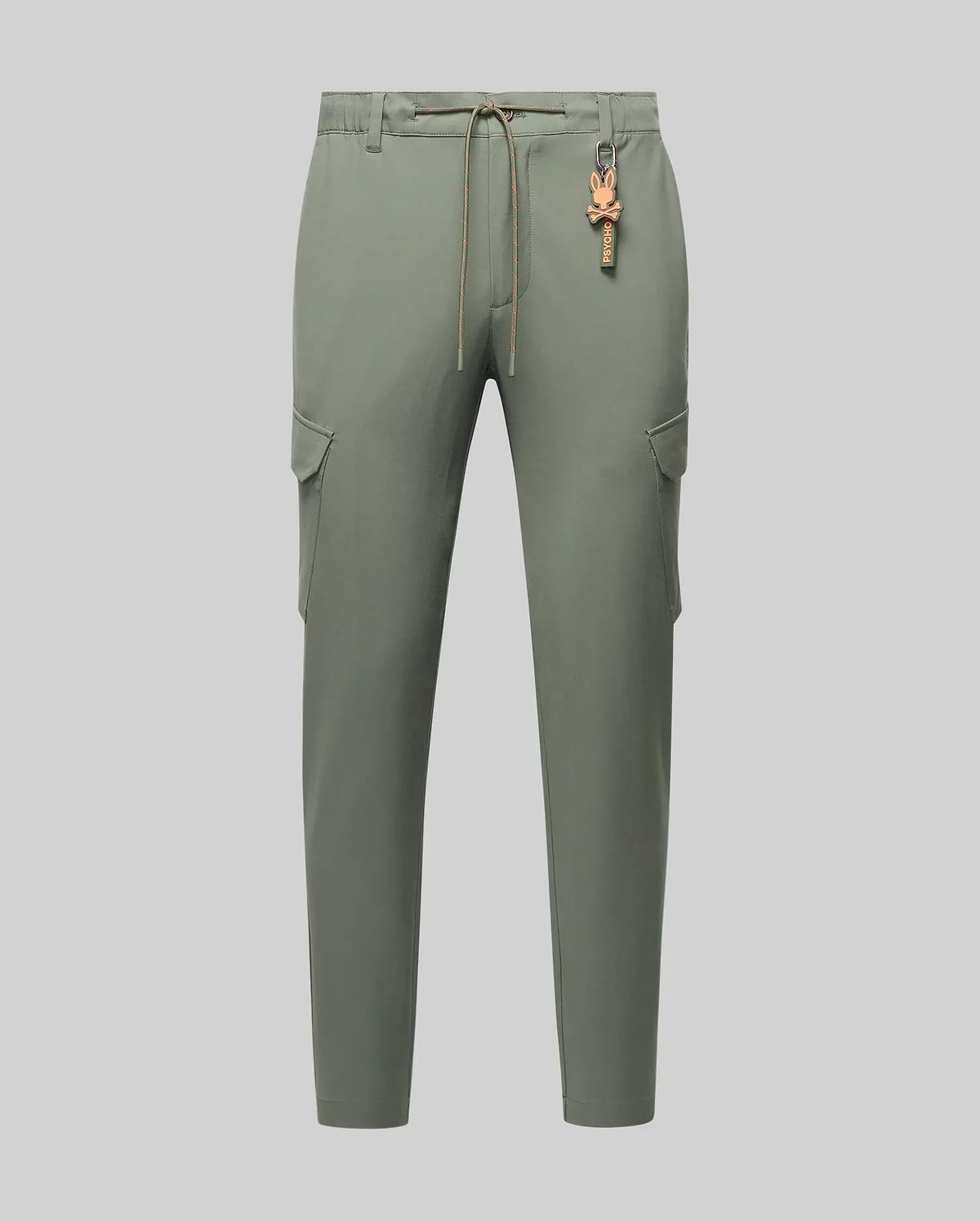 Mens Luka Cargo Pant in sage green, featuring a relaxed fit, smooth fabric, side cargo pockets, an orange drawstring, and a distinctive orange Psycho Bunny skull keychain.
