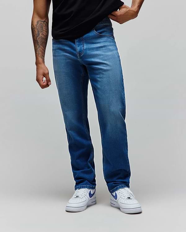 Mens Ace Knit Denim Pant, a classic straight fit jean in a versatile medium wash blue knit denim fabric, featuring subtle whiskering and fading for a refined streetwear look.