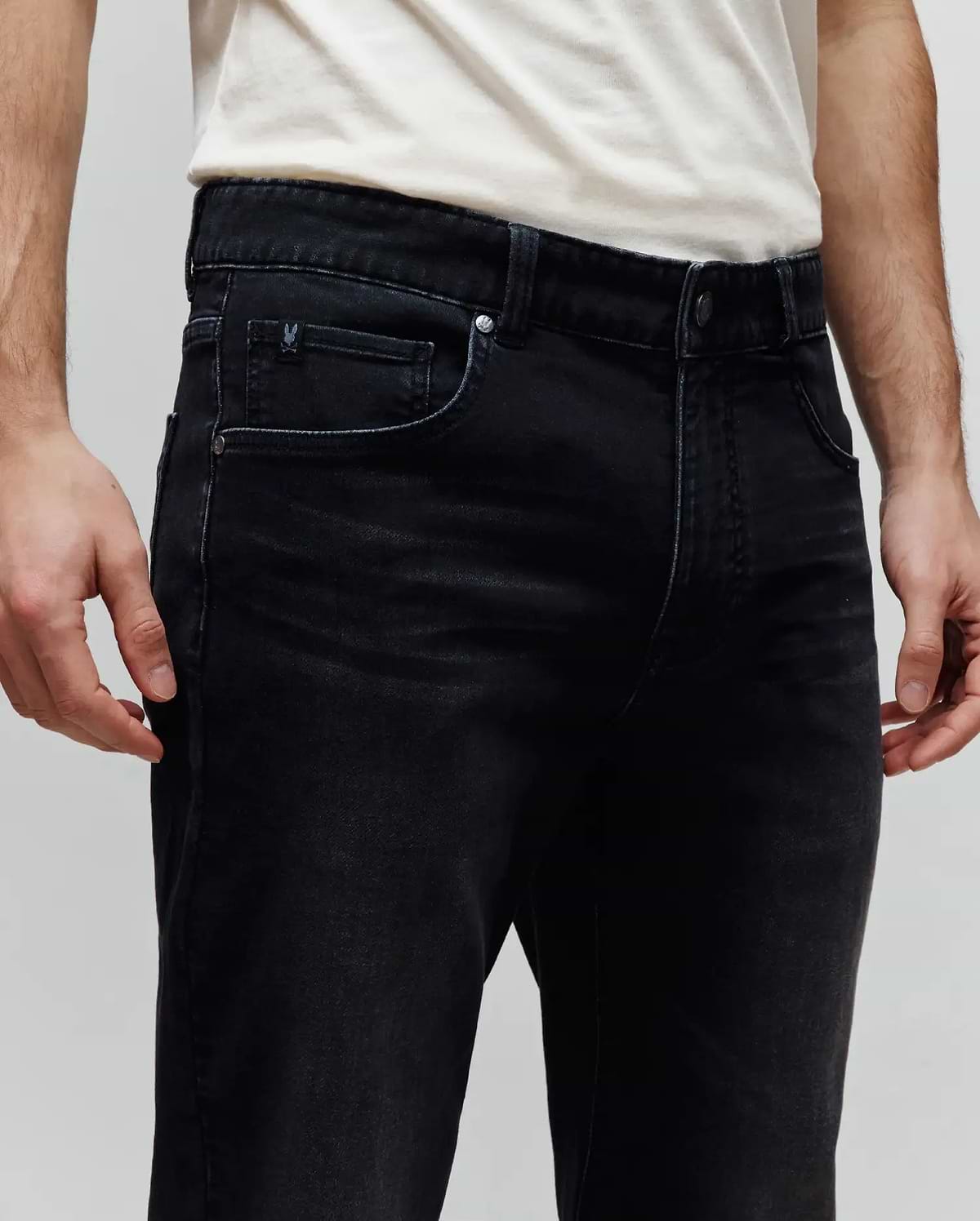 Mens Ace Knit Denim Pant, black knit denim with a classic fit, featuring a small embroidered Psycho Bunny skull logo on the coin pocket and branded metal hardware.