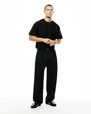 Black relaxed-fit jersey t-shirt featuring a subtle tonal Psycho Bunny skull logo on the left chest, paired with Men's Wayde Wide-Leg Pleated Pants in a smooth black fabric. (1)