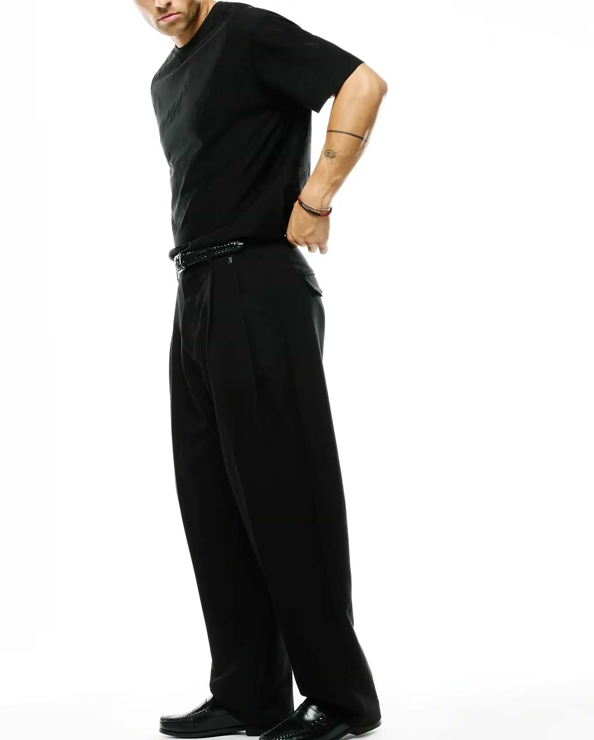 Black Psycho Bunny jersey t-shirt with subtle tonal bunny skull pattern and classic fit, paired with black Men's Wayde Wide-Leg Pleated Pants in a relaxed woven fabric. (4)