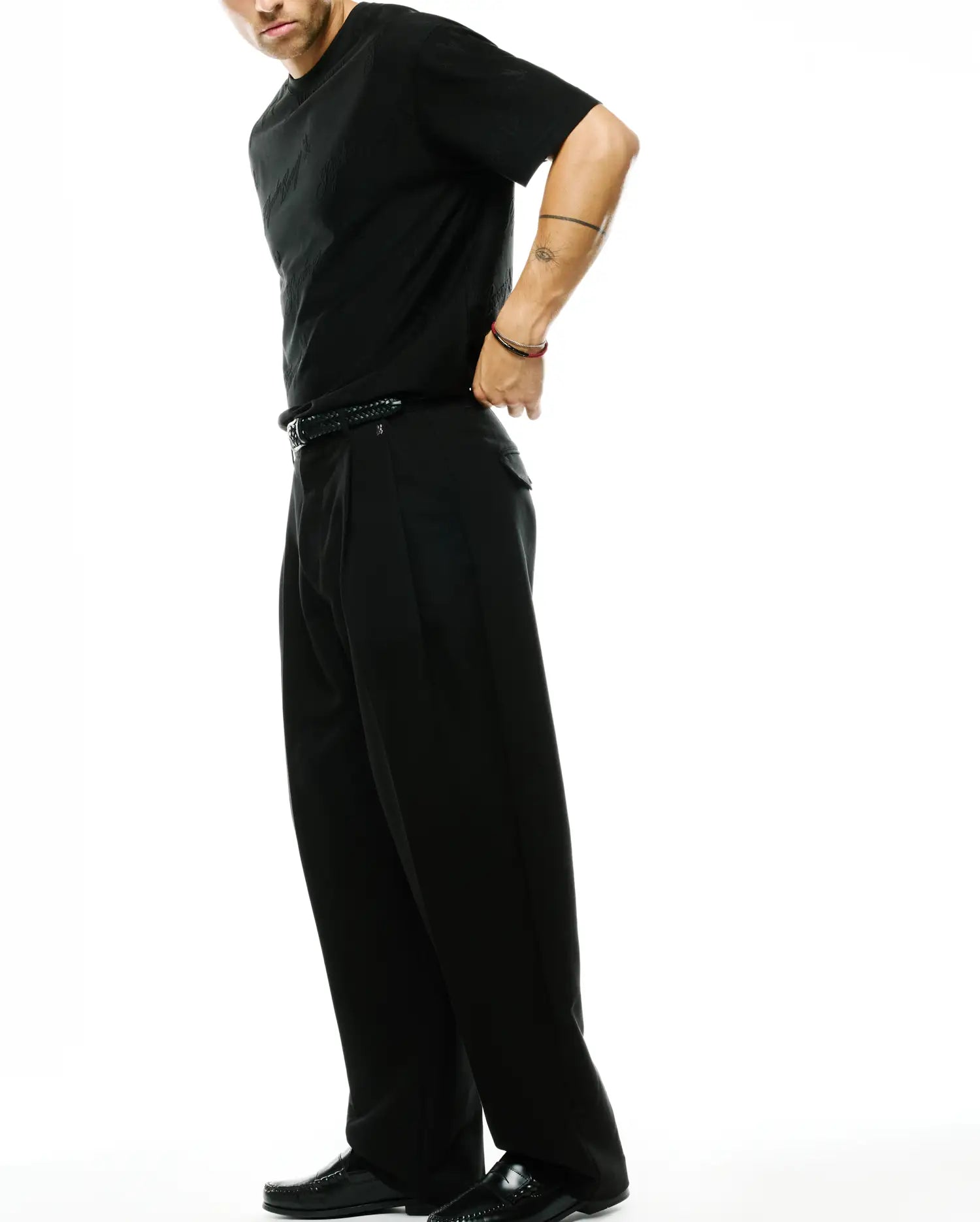 Black Psycho Bunny jersey t-shirt with subtle tonal bunny skull pattern and classic fit, paired with black Men's Wayde Wide-Leg Pleated Pants in a relaxed woven fabric. (4)