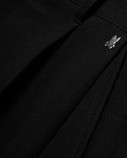 Men's Wayde Wide-Leg Pleated Pants in black, featuring a subtle fabric texture, wide-leg fit, and a small metallic silver Psycho Bunny skull logo near the waistband. (6)