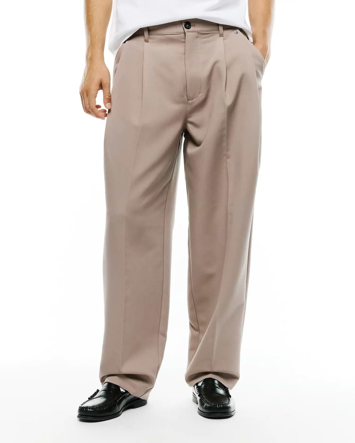 Men's Wayde Wide-Leg Pleated Pants in taupe, featuring a relaxed wide-leg fit, smooth woven fabric, front pleats, a black button closure, and a small embroidered Psycho Bunny skull logo near the right front pocket. (2)