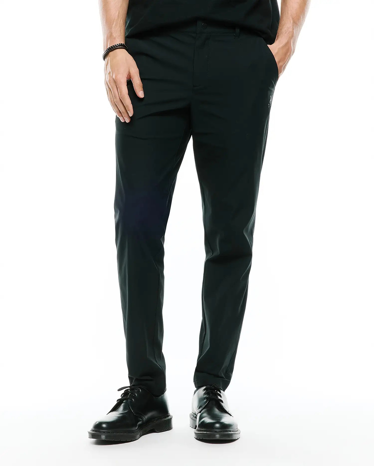 Mens Edward 10k Tapered Pant in dark green, featuring a slim tapered fit and smooth performance fabric, with a small embroidered Psycho Bunny skull logo on the upper right thigh.