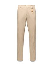 Mens Edward 10k Tapered Pant in beige, crafted from smooth performance fabric with a tapered fit, highlighted by a vibrant orange Psycho Bunny skull keychain on the front belt loop.