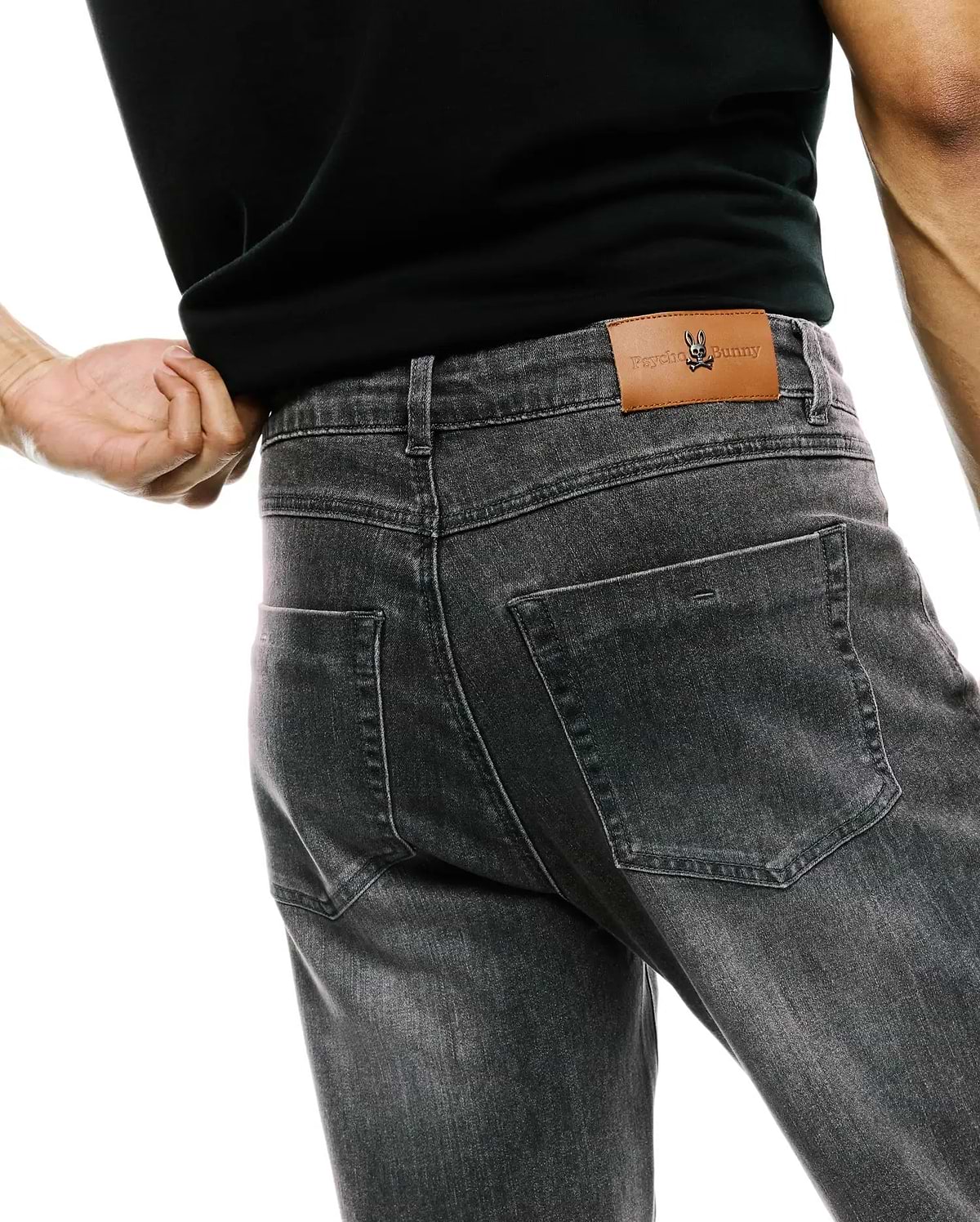 Mens Emerson Denim Pant in washed black, featuring a classic fit, faded denim texture, and a brown leather back waistband patch with an embossed Psycho Bunny logo.