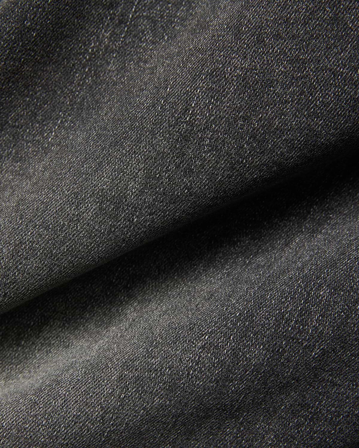 Mens Emerson Denim Pant featuring a dark charcoal grey denim fabric with a visible twill weave and subtle light flecks, creating a textured, washed appearance.