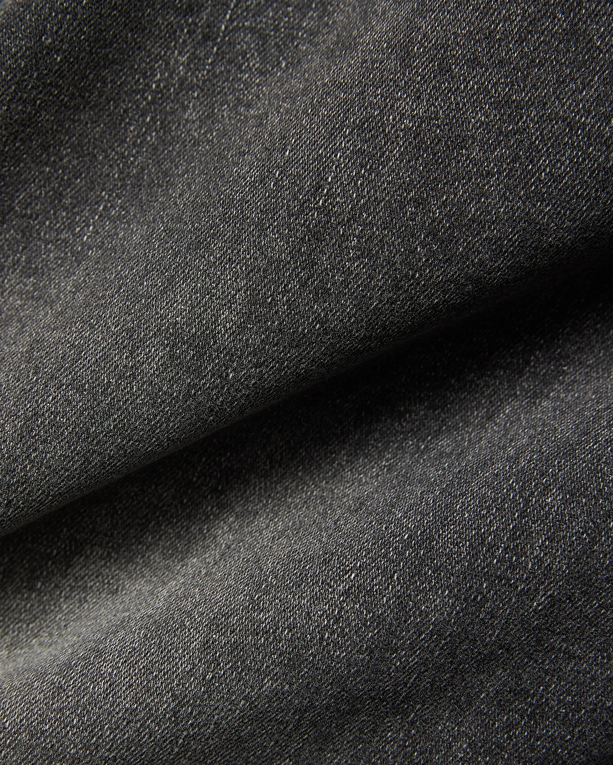 Mens Emerson Denim Pant featuring a dark charcoal grey denim fabric with a visible twill weave and subtle light flecks, creating a textured, washed appearance.